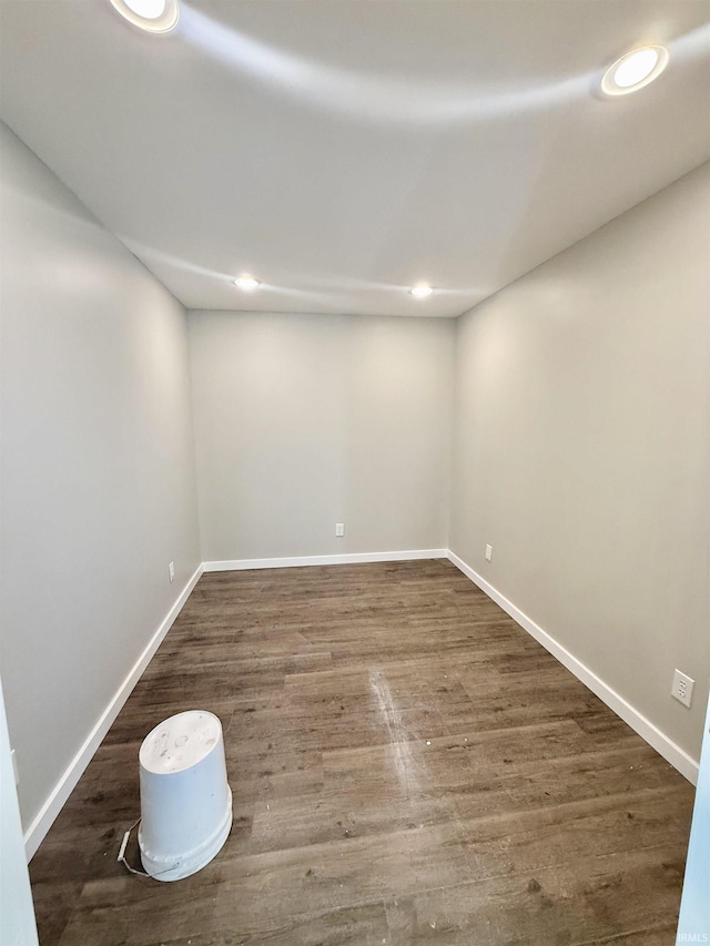 unfurnished room with dark hardwood / wood-style flooring