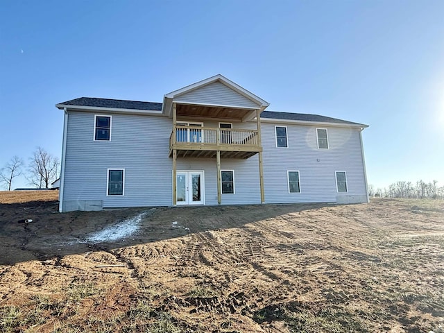 rear view of property with a balcony