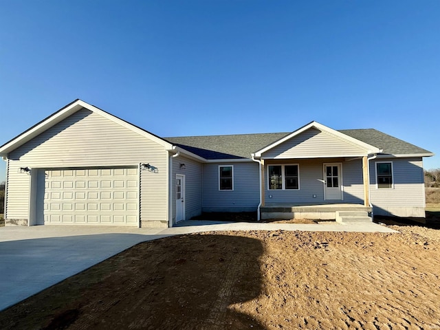 single story home featuring a garage and covered porch