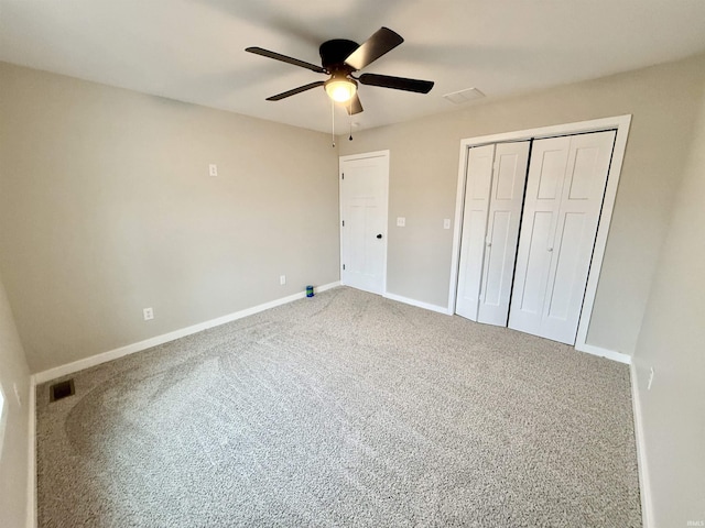 unfurnished bedroom featuring ceiling fan, carpet floors, and a closet