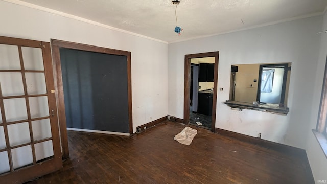 spare room featuring dark hardwood / wood-style floors and ornamental molding