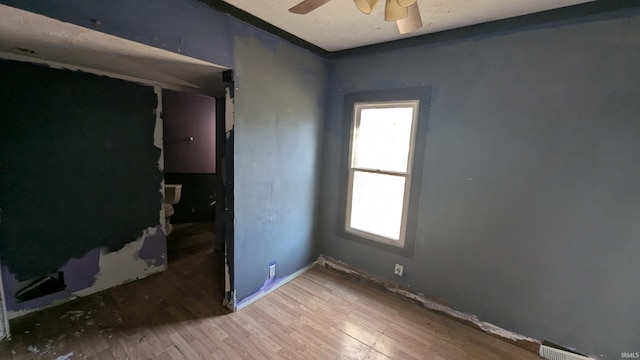 unfurnished room featuring ceiling fan and wood-type flooring