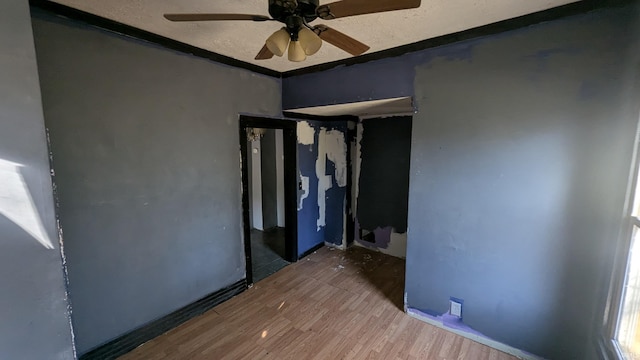 unfurnished bedroom featuring hardwood / wood-style floors and ceiling fan