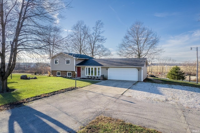 tri-level home featuring a garage and a front lawn