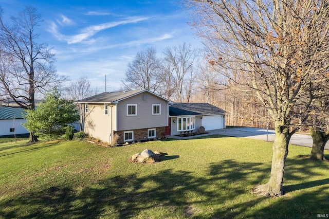 rear view of property with french doors, a yard, and a garage