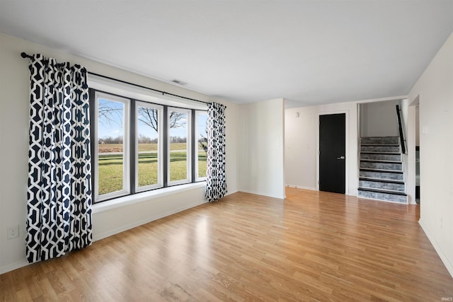 unfurnished living room with light hardwood / wood-style floors