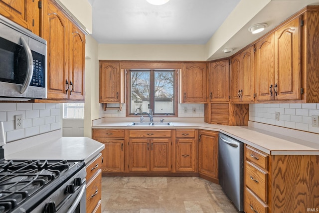 kitchen featuring backsplash, a healthy amount of sunlight, and stainless steel appliances