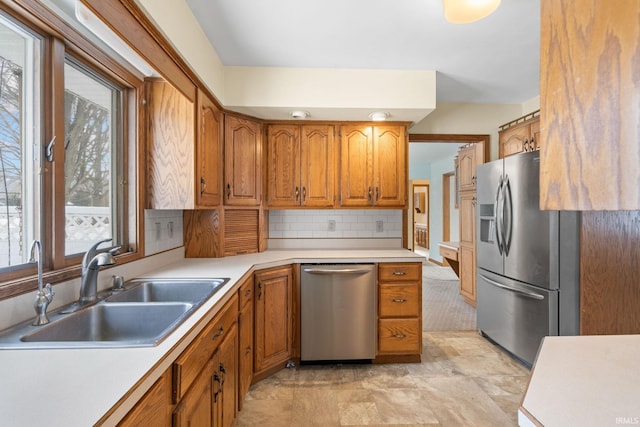 kitchen featuring stainless steel appliances, tasteful backsplash, and sink