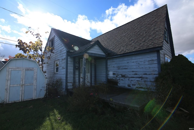 view of front of house with a storage shed