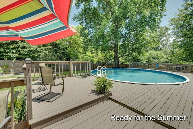 view of pool with a wooden deck