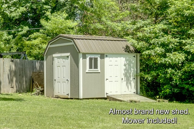 view of outdoor structure featuring a lawn