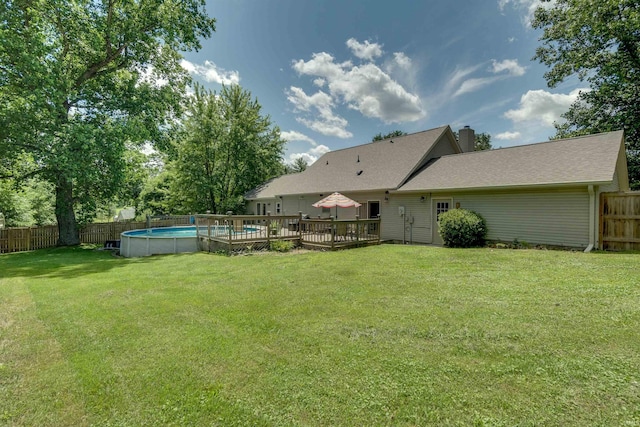 view of yard with a swimming pool side deck