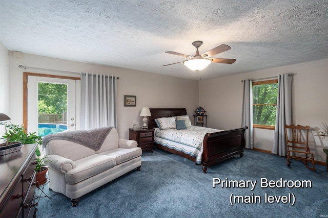 carpeted bedroom with multiple windows, ceiling fan, a textured ceiling, and access to exterior