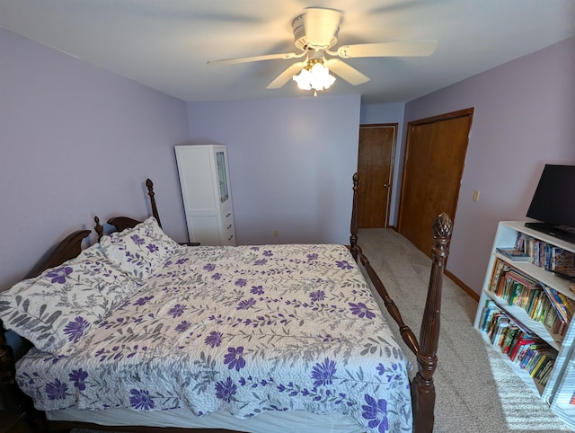 carpeted bedroom featuring ceiling fan and a closet