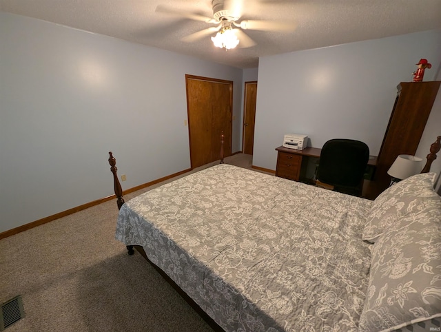 carpeted bedroom with a textured ceiling and ceiling fan