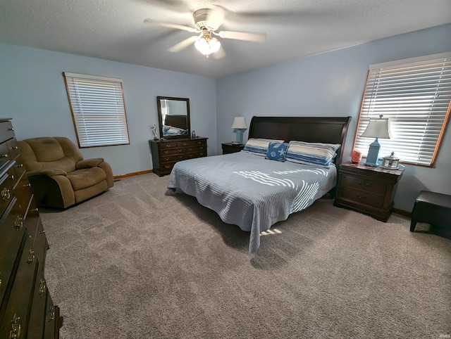 carpeted bedroom featuring a textured ceiling and ceiling fan