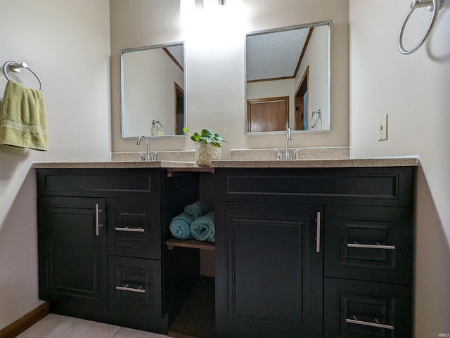 bathroom with tile patterned floors and vanity