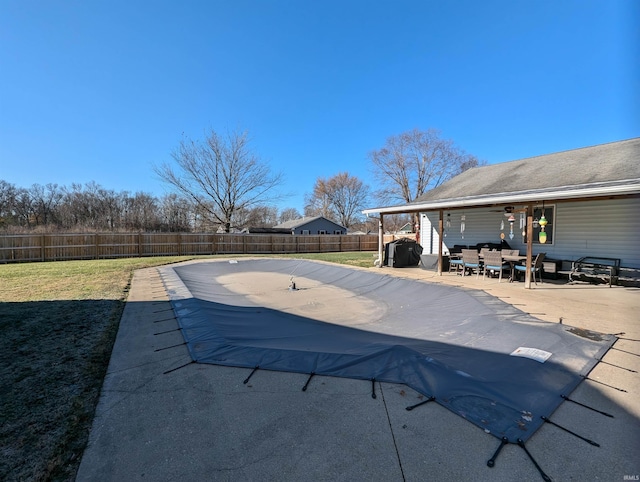 view of swimming pool featuring a lawn and a patio