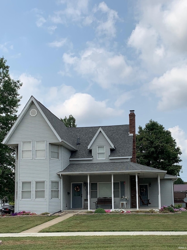 view of front of home with a front lawn and covered porch