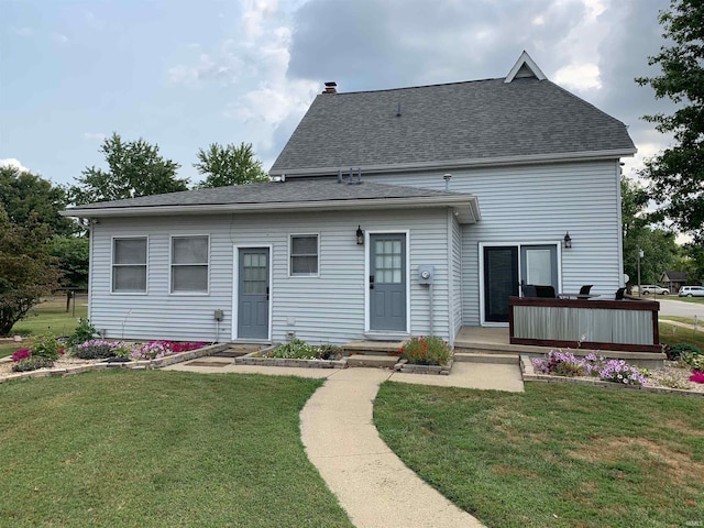 rear view of house with a yard