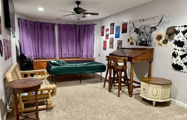 interior space with ceiling fan and light colored carpet