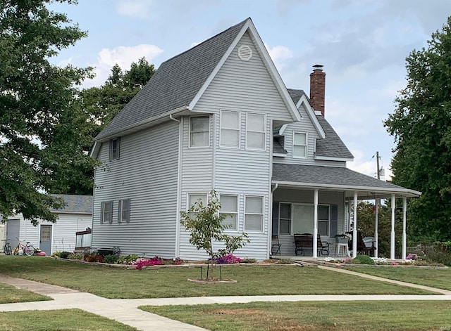 view of front of home featuring a front lawn and covered porch