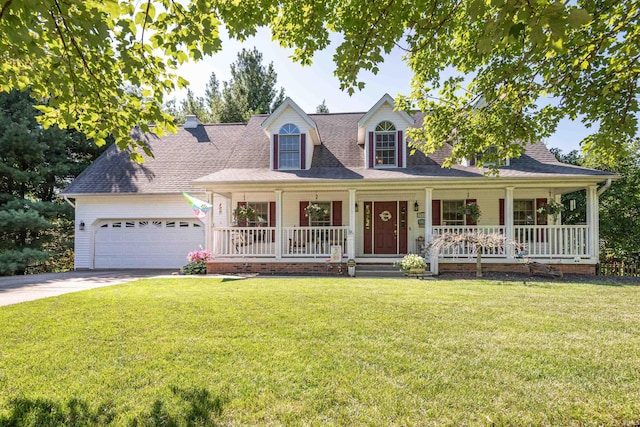 view of front of property with a front lawn, covered porch, and a garage