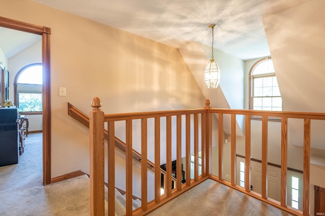 hall with light carpet and lofted ceiling