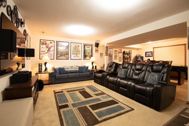 home theater room featuring light colored carpet and a textured ceiling