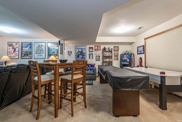 interior space with carpet flooring, a textured ceiling, and pool table