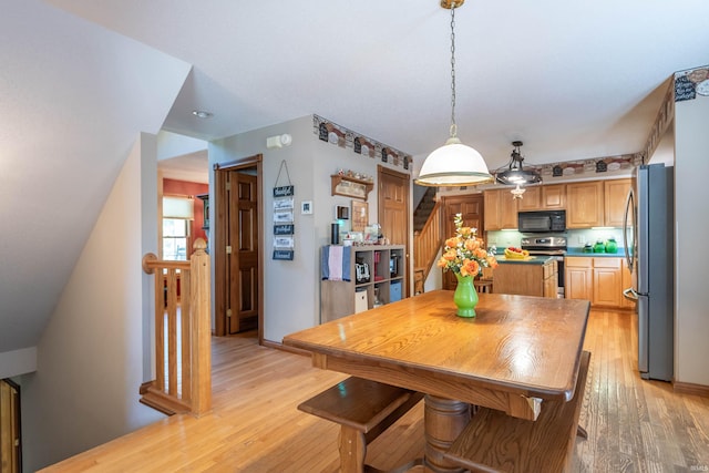 dining space with light wood-type flooring