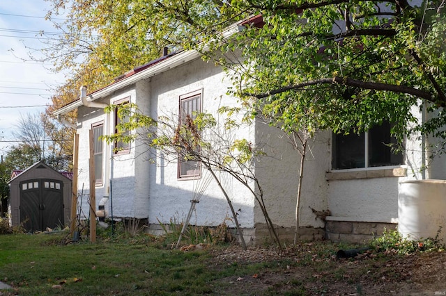 view of property exterior featuring a storage shed