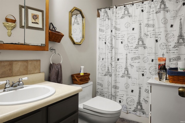 bathroom with walk in shower, vanity, and toilet