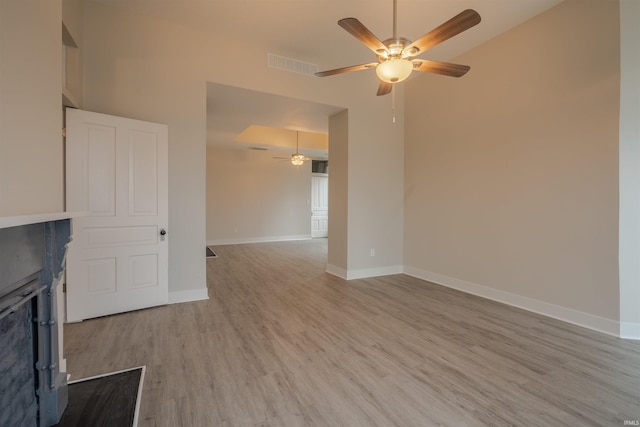 unfurnished living room with light hardwood / wood-style floors and ceiling fan