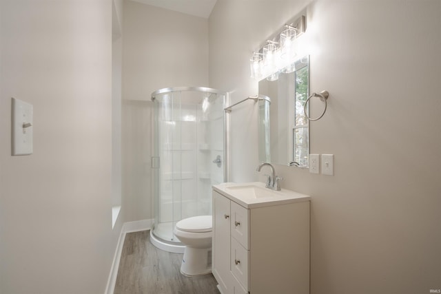 bathroom with vanity, hardwood / wood-style flooring, toilet, and walk in shower