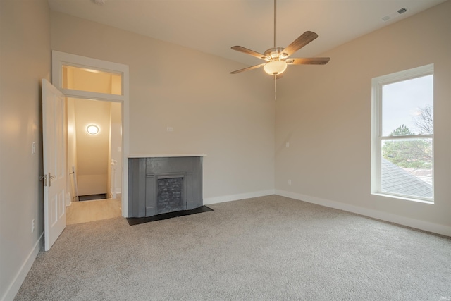 unfurnished living room with ceiling fan and light colored carpet