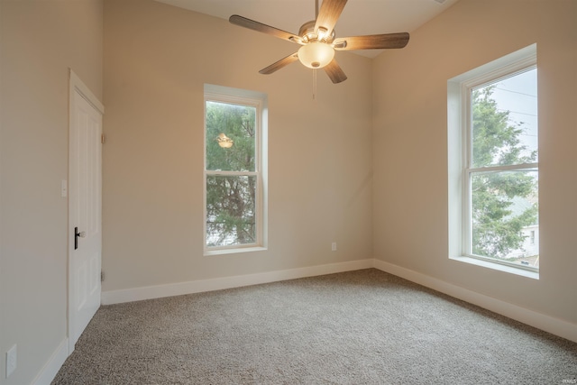 carpeted empty room featuring ceiling fan and a healthy amount of sunlight