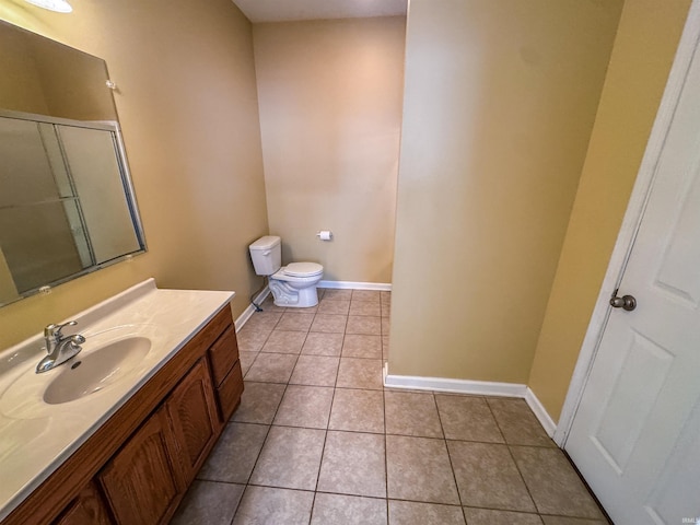 bathroom with tile patterned floors, vanity, and toilet