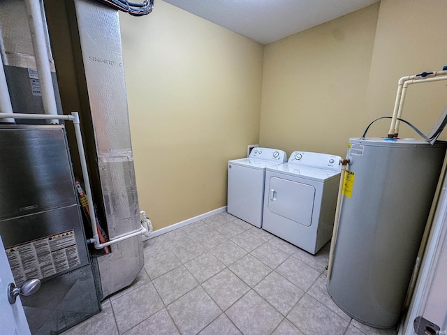 laundry area featuring heating unit, separate washer and dryer, light tile patterned floors, and water heater