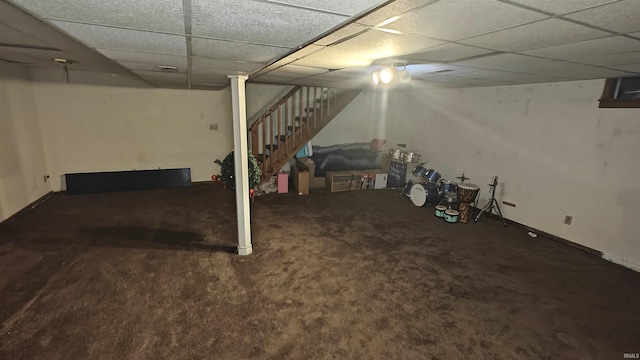 basement featuring carpet flooring and a paneled ceiling