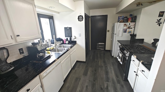 kitchen with decorative backsplash, white appliances, sink, white cabinets, and dark hardwood / wood-style floors