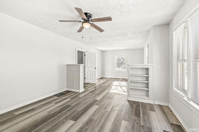 unfurnished living room with wood-type flooring, a textured ceiling, and ceiling fan