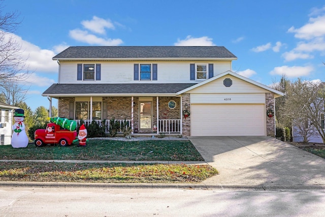 front of property featuring covered porch, a front yard, and a garage