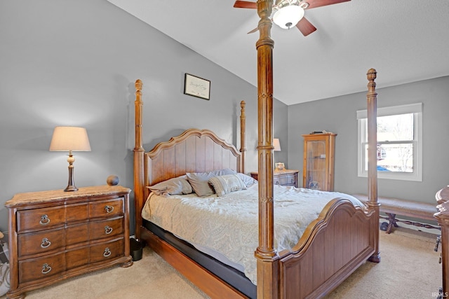 bedroom featuring ceiling fan, light carpet, and lofted ceiling