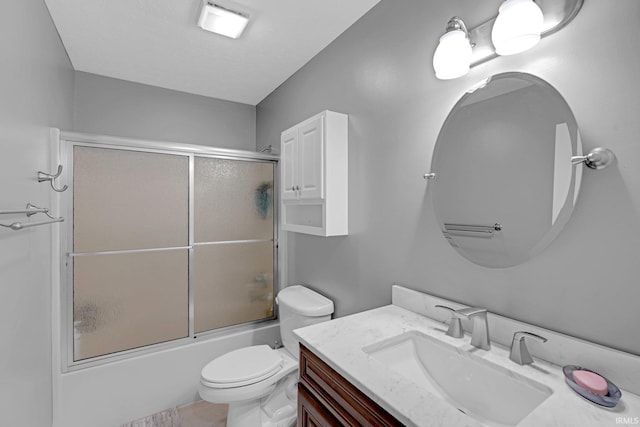 full bathroom featuring vanity, enclosed tub / shower combo, and toilet