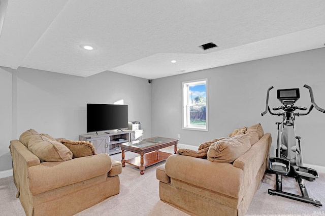 carpeted living room featuring a textured ceiling