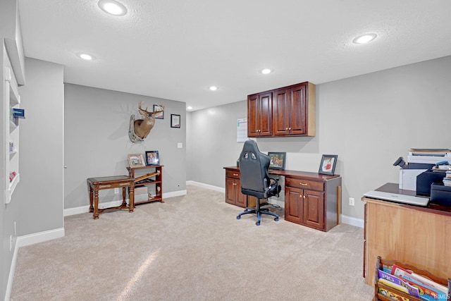 carpeted home office with a textured ceiling