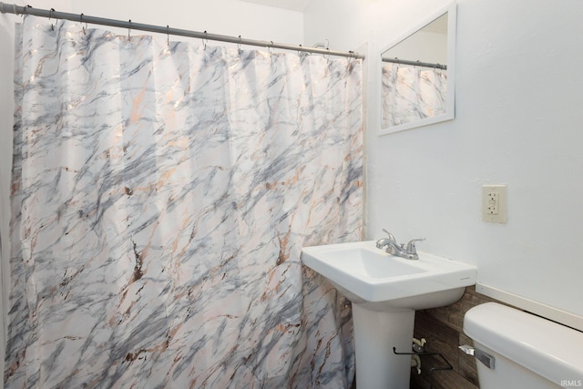 bathroom with toilet, tile walls, and curtained shower