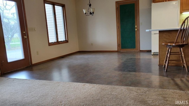 unfurnished dining area with plenty of natural light and a chandelier