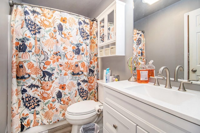 bathroom with hardwood / wood-style floors, vanity, and toilet